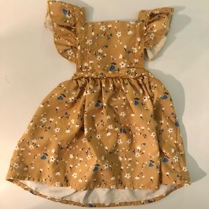 Adorable Fall dress with straps around the shoulders to the back.